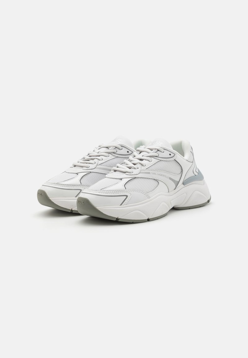 Baskets basses blanches et grises avec semelles épaisses, panneaux en maille et en cuir, lacets et marque Karl Lagerfeld sur le côté et la languette.