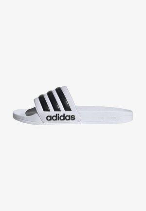 White slide sandal featuring three textured black stripes and an embossed black "adidas" logo on the strap. Soft cloudfoam sole.