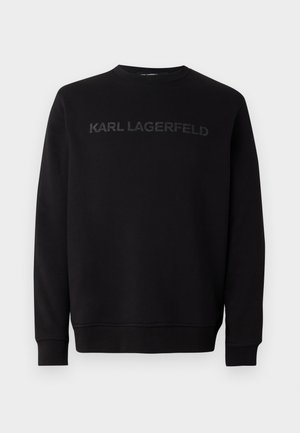 Felpa nera realizzata in morbido tessuto, con scollo rotondo e maniche lunghe. Sul davanti è stampato un logo tono su tono "KARL LAGERFELD".