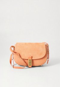 Peach suede crossbody bag with a flap closure, gold-tone hardware, adjustable strap, and embossed logo detail on the front.