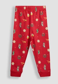 Leggings roșii dintr-un material moale, având un model tematic de sărbători cu ciorapi, coroane, stele și instrumente muzicale. Talie elastică.