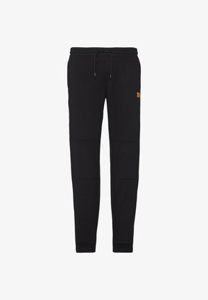 Zwarte katoenen sweatpants met elastische tailleband en trekkoord. Voorzien van zijzakken en contrasterend logo op de bovenste dij. Soepele textuur.