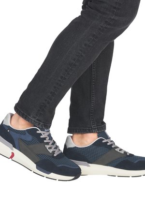 Navy and gray running shoes with a textured upper, mesh accents, and a rubber sole. Features laces and a small red accent near the heel.