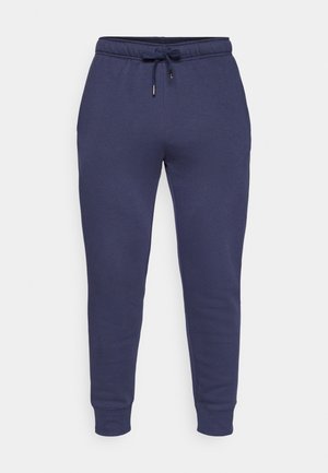 Navy blauwe joggingbroek met een trekkoord in de taille, taps toelopende benen en ribbelmanchetten. Zachte stof met minimale stikdetails.