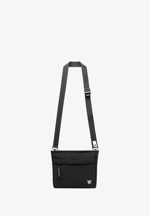 Black fabric crossbody bag with an adjustable strap, zippered main compartment, front pocket, and logo detail on the front.