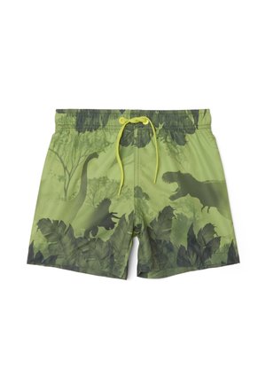 Short de bain vert avec des silhouettes de dinosaures vert foncé, dont un T-Rex, et des motifs de feuillage tropical, avec une ceinture à cordon jaune.