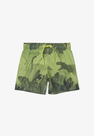 Short de bain vert avec des silhouettes de dinosaures vert foncé, dont un T-Rex, et des motifs de feuillage tropical, avec une ceinture à cordon jaune.