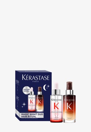 Kérastase Magic Night Duo Haarritual-Set mit zwei Glasflaschen, eine pink und eine braun, in einer blauen Schachtel mit weißem Text und Sternen.