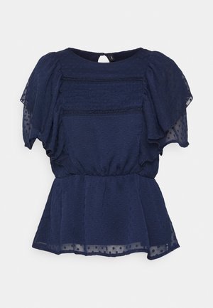 Navyblauw top met korte, opgeblazen mouwen, textuur met stippenpatroon, gerimpelde bustier en een geplooide peplumzoom. Sleutelhoedopening aan de achterkant.