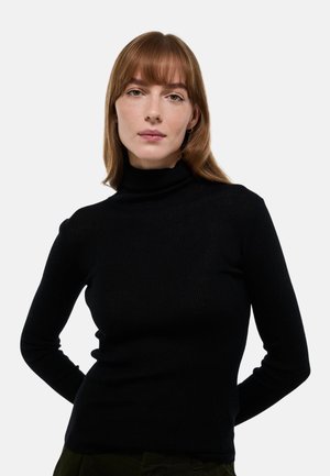 Pull noir à col roulé côtelé avec manches longues, fabriqué à partir d'un tissu texturé, au design ajusté et légèrement extensible au niveau du col.