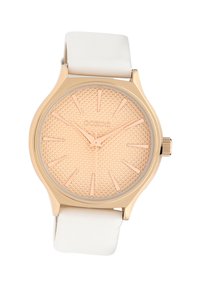 Round watch with a textured rose gold face, white silicone band, and gold accents, featuring prominent hour markers and hands.