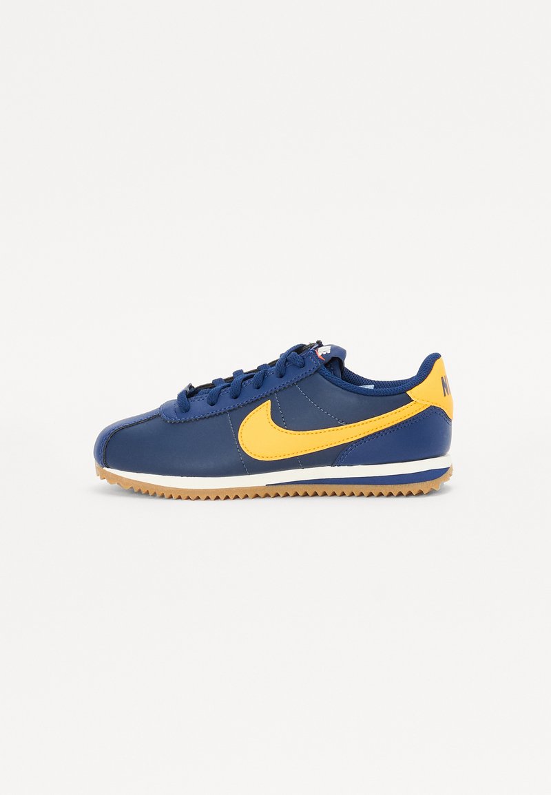 Tenis de couro azul com swoosh amarelo, design de amarração, entressola branca e sola de borracha. Possui um bico arredondado e detalhes cosidos.
