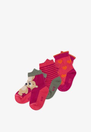 Set of three pairs of children's socks: one with a bear graphic, one with pink stripes, and one with hearts on a bright pink background.