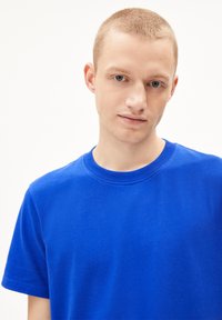 Königsblaue T-Shirt mit Rundhalsausschnitt, kurzen Ärmeln und weichem Baumwollmaterial, das ein schlichtes, unbeschränktes Design und eine modische Passform aufweist.