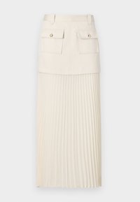 Gonna plissettata color crema con parte superiore aderente, due tasche frontali e bottoni decorativi. Il materiale è liscio con una sezione inferiore fluente e testurizzata.