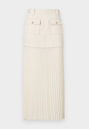 Krämfärgad veckad kjol med en figursydd överdel med två framfickor och dekorativa knappar. Materialet är mjukt, med en flödande, texturerad nederdel.