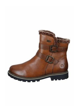 Bottes de cheville en cuir marron avec deux boucles latérales, doublure en fausse fourrure au revers et semelle extérieure en caoutchouc noir robuste.