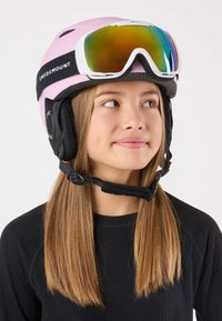 Pink ski helmet with black ear pads and strap labeled "SWEDMOUNT." White ski goggles with a reflective lens positioned above the forehead.