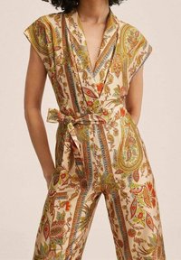 Mono estampado con fondo crema, diseños vibrantes de paisley y flores en rojo, verde y azul, con cintura ceñida y mangas cortas.