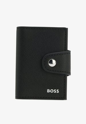 Black bifold wallet made of textured material, featuring a silver snap button closure and embossed logo on the front.
