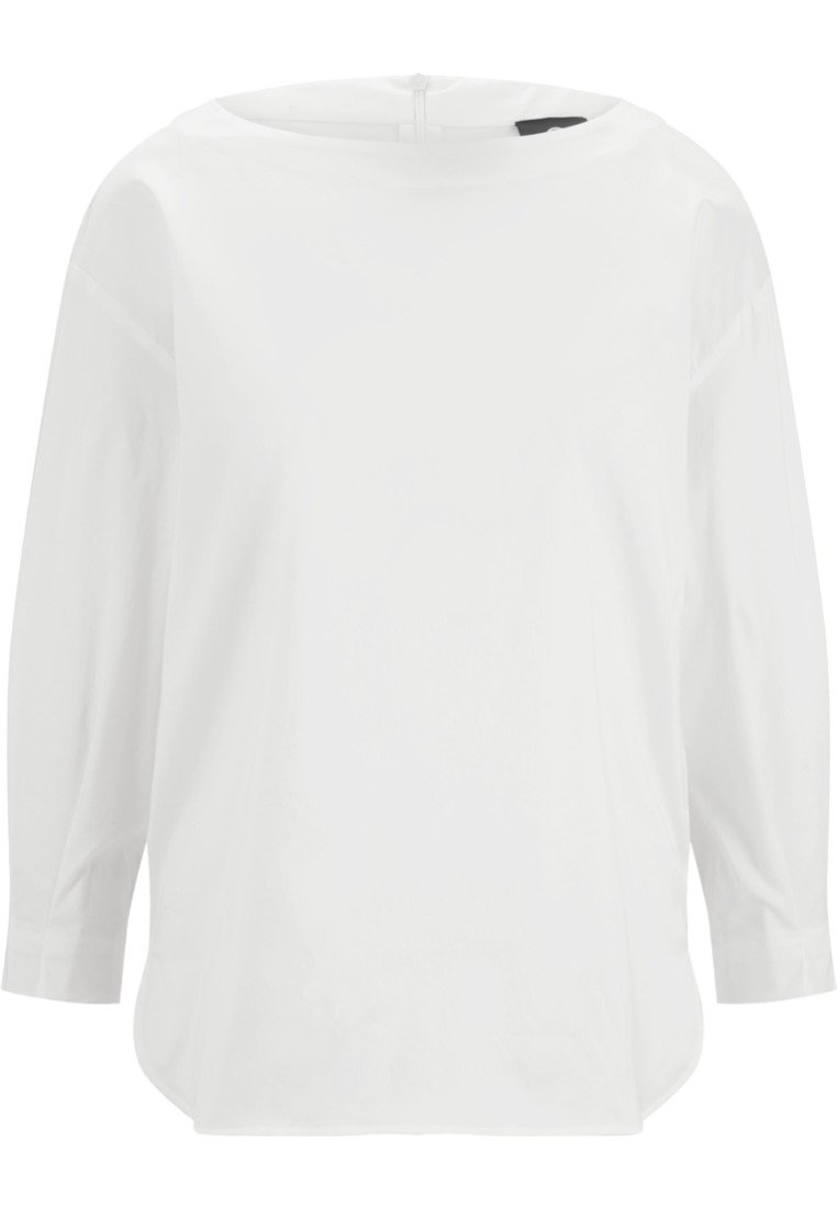 Blouse blanche à manches longues avec un col rond et un ourlet légèrement incurvé, présentée sur un fond uni.