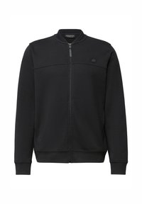 Svart zip-up jacka gjord av mjukt tyg. Har en ståkrage, ribbade muddar och en minimal design med en liten logotyp på bröstet.