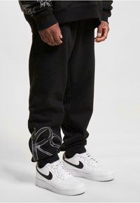 Rocawear Tracksuit bottoms - black