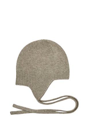 Bonnet d'hiver gris en tricot avec rabats pour les oreilles et deux longues attaches sur fond blanc.