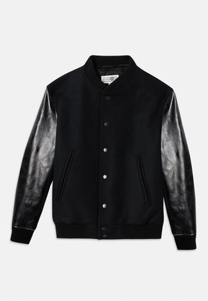 Black varsity jacket with wool body and shiny black leather sleeves. Features snap buttons and side pockets, with ribbed cuffs and hem.