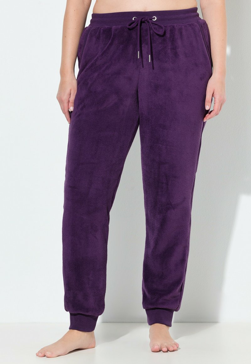 Purple fleece joggers with an elastic waistband, drawstring, and cuffed ankles; soft texture with a smooth finish.