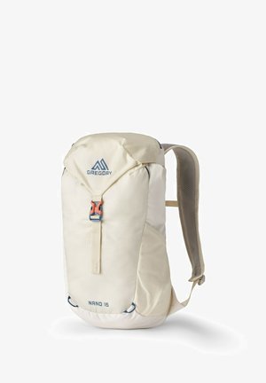 Light beige backpack with textured fabric, adjustable gray straps, a blue logo, and a bright orange buckle. Compact design for everyday use.