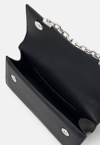 Borsa a tracolla nera in pelle con catena, hardware in argento e interno liscio con un unico scomparto e chiusura magnetica.