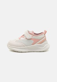 White athletic shoes with pink accents, mesh upper, Velcro strap, padded collar, textured sole, and streamlined design for comfort.