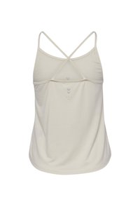 Light beige sleeveless top with a cross-back design, made of soft fabric. Features subtle printed accents on the back.