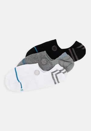 Four pairs of no-show socks in black, gray, and white. Features include contrasting stripes, a circular logo, and varying color accents.