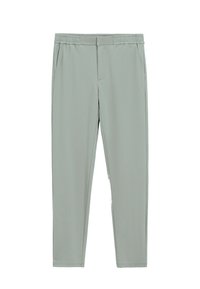 Pantalons de jogging gris clair, extensibles, avec une taille élastique, deux poches latérales et un design de jambe fuselée. Texture de tissu lisse sans motifs.