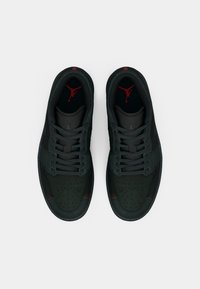 Μαύρα αθλητικά παπούτσια με γυαλιστερή επένδυση από δέρμα και δίχτυ, διακοσμημένα με κόκκινες ραφές. Διαθέτουν τρυπητό τμήμα στα δάχτυλα και εφαρμογή με κορδόνια.