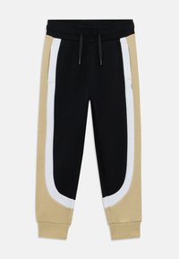 Μαύρο, μπεζ και λευκό παντελόνι φόρμας με ρίγες στο πλάι και ελαστική μέση. Κατασκευασμένο από απαλό βαμβακερό υλικό με χαλαρή εφαρμογή.