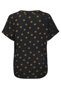 Blouse noire à manches courtes avec un motif à pois en brun doré, à la coupe décontractée et avec un ourlet arrondi à l'arrière. Tissu léger et lisse.