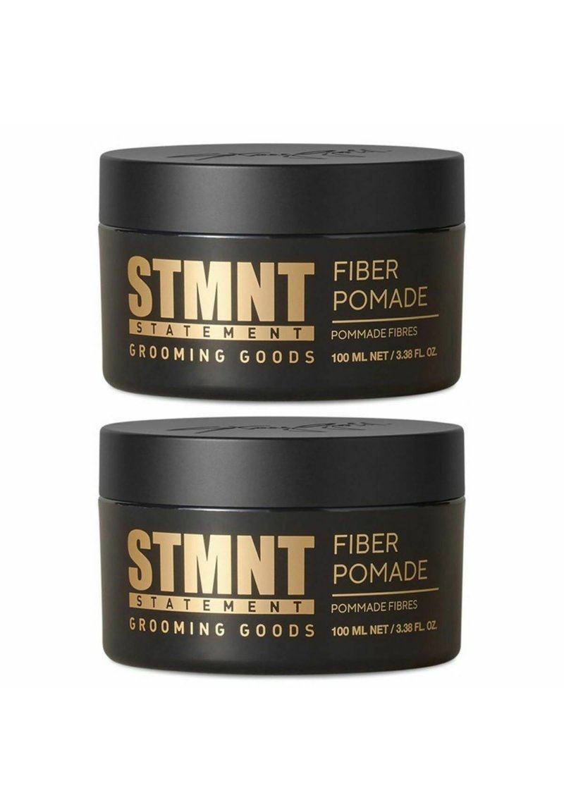 Black containers of STMTNT Fiber Pomade with gold text. Each jar holds 100 ml. Smooth surface with a rounded lid and minimalistic design.