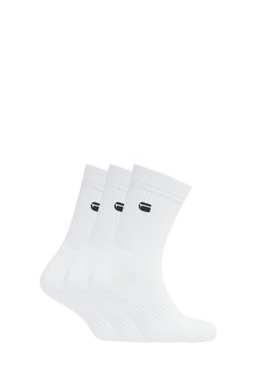 Three pairs of white crew socks with ribbed cuffs and a small black logo near the top on a plain white background.