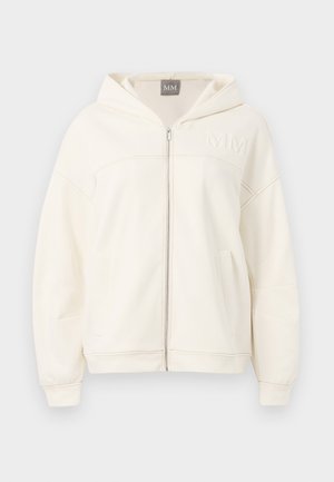 Cream-colored zip-up hoodie made of soft fabric featuring a hood, ribbed cuffs, and kangaroo pockets. Embroidered "MM" logo on chest.