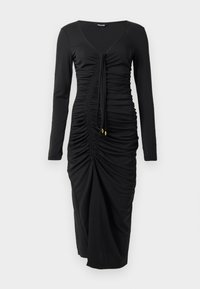 Long-sleeve black dress made of stretchy fabric, featuring a V-neck, ruched detail, and drawstring at the front with gold accents at the ends.