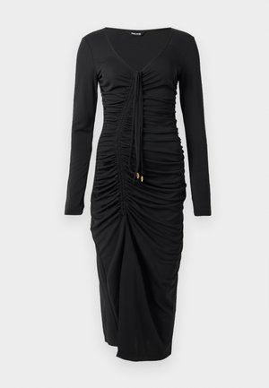 Long-sleeve black dress made of stretchy fabric, featuring a V-neck, ruched detail, and drawstring at the front with gold accents at the ends.