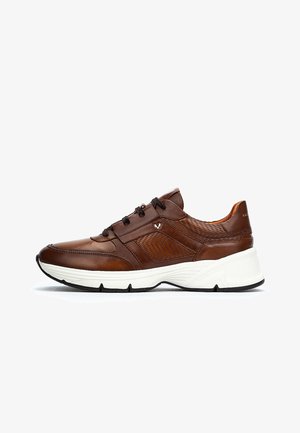 Brune lædersneakers med perforerede sidepaneler, sorte snørebånd og tykk hvid sål med sort mønster, vist i højre profil.