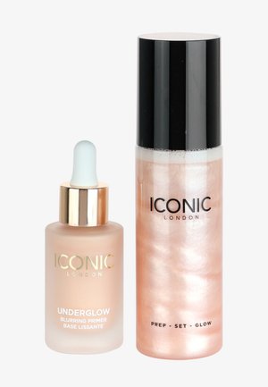 Underglow blurring primer in a frosted glass bottle with a gold cap, and a prep set glow spray in a pink metallic bottle with a black cap.