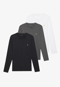Tres camisetas de manga larga en negro, gris y blanco, hechas de algodón, con un cuello redondo y un pequeño logo amarillo en el pecho.