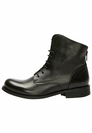 Black leather ankle boots with a smooth finish, round toe, lace-up front, and side zipper. Flat sole and minimal design accents.