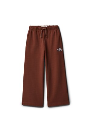 Brune vide joggebukser med elastisk linning og snøring, med en liten Calvin Klein-logo på øvre venstre lår.