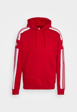 Sweat à capuche rouge avec des bandes blanches le long des manches, poche avant et logo Adidas sur le haut des bras.
